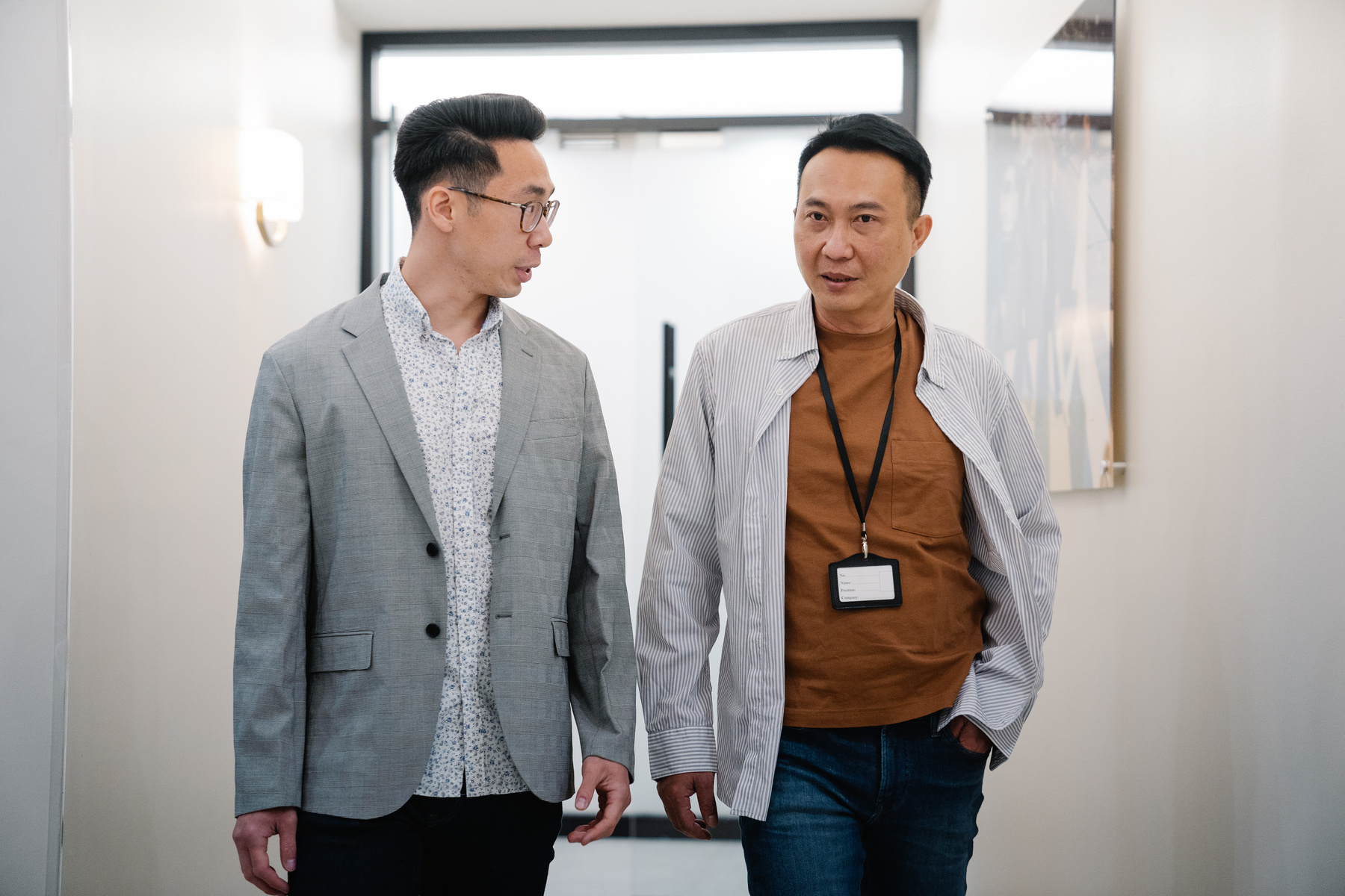 Two Male Colleagues walking alongside each other 